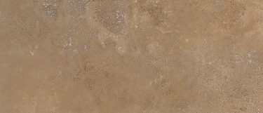 a noce travertine countertop surface that features a deep brown color with details in beige, silver, and gold