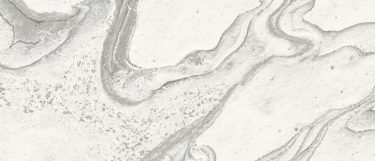 a Liquid Sky sintered stone countertop surface that has a white base with a flowing swirling pattern of gray veins