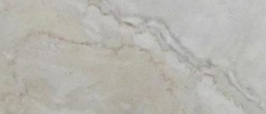 a Dolce Vita marble countertop surface that features subtle tones of peach and gray over the ivory white background