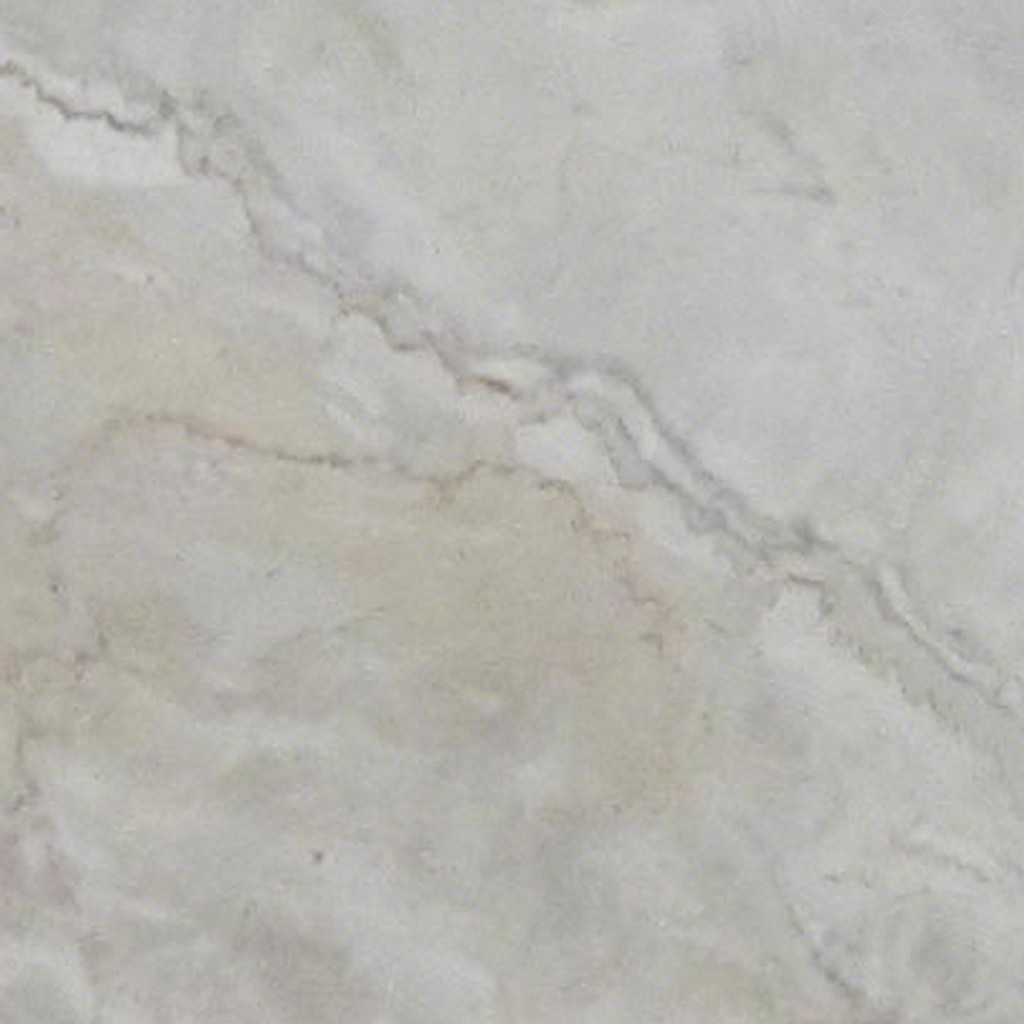 a Dolce Vita marble countertop surface that features subtle tones of peach and gray over the ivory white background