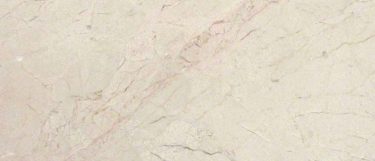 a Crema Marfil Classic marble countertop surface that features blends of golds and beiges over the cream background