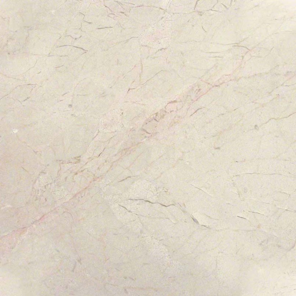 a Crema Marfil Classic marble countertop surface that features blends of golds and beiges over the cream background