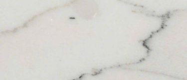 a Calacatta Lincoln marble countertop surface that has veins in gray over the white background
