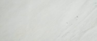 an Arabescato Carrara marble countertop surface that features white and dusty gray swirls