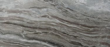a Fantasy Gray marble countertop surface that has deep gray veins in a wavy pattern