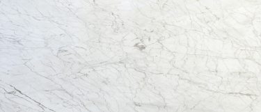 a Carrara Gioia marble countertop surface that has gray veins over the white base
