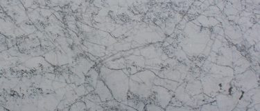 a statuario venato marble countertop surface that features blue-gray veining pattern over the white base