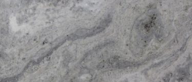 a Grey Fantasy marble countertop surface that has deep shades of gray dark veining and cloudy-white details