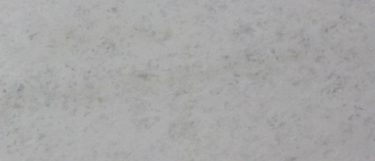 an Everest White marble countertop surface that features delicate veins and plumes of gray over the white background