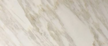 a Calacatta Gold marble countertop surface that features gray and gold veining over the white background