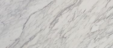 a Calacatta Marble countertop surface that has thick bold veining in gray over the white background
