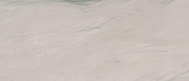 a Zermatt Quartzite countertop surface that features deamy whites and gray veins over the white-beige base