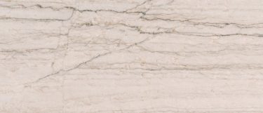 a white Macaubas quartzite countertop surface with dark charcoal veins against its a creamy white base