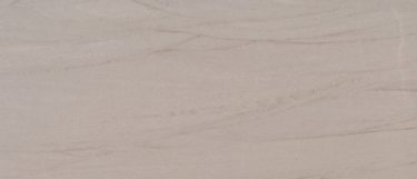 a Kalahari quartzite countertop surface that features a blend of creamy beiges with subtle linear veins