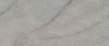 a Glacier Wave quartzite countertop surface that features soft dove gray background with wave patterns in various shades of gray