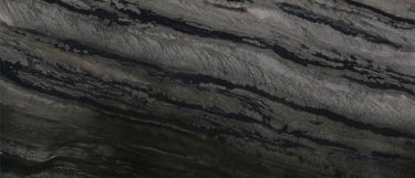 a Galapagos quartzite countertop surface that features dramatic charcoals and grays against the soft creams linear veins