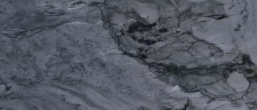 a Cirrus Gray quartz countertop surface that features charcoal waves with vein details