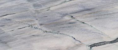 an Azul Imperiale quartzite countertop surface that blue hues together with gold linear veins