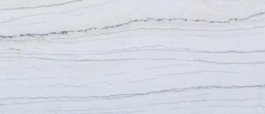 a Macaubas Fantasy quartz countertop surface that features white and gray veins over the soft gray background