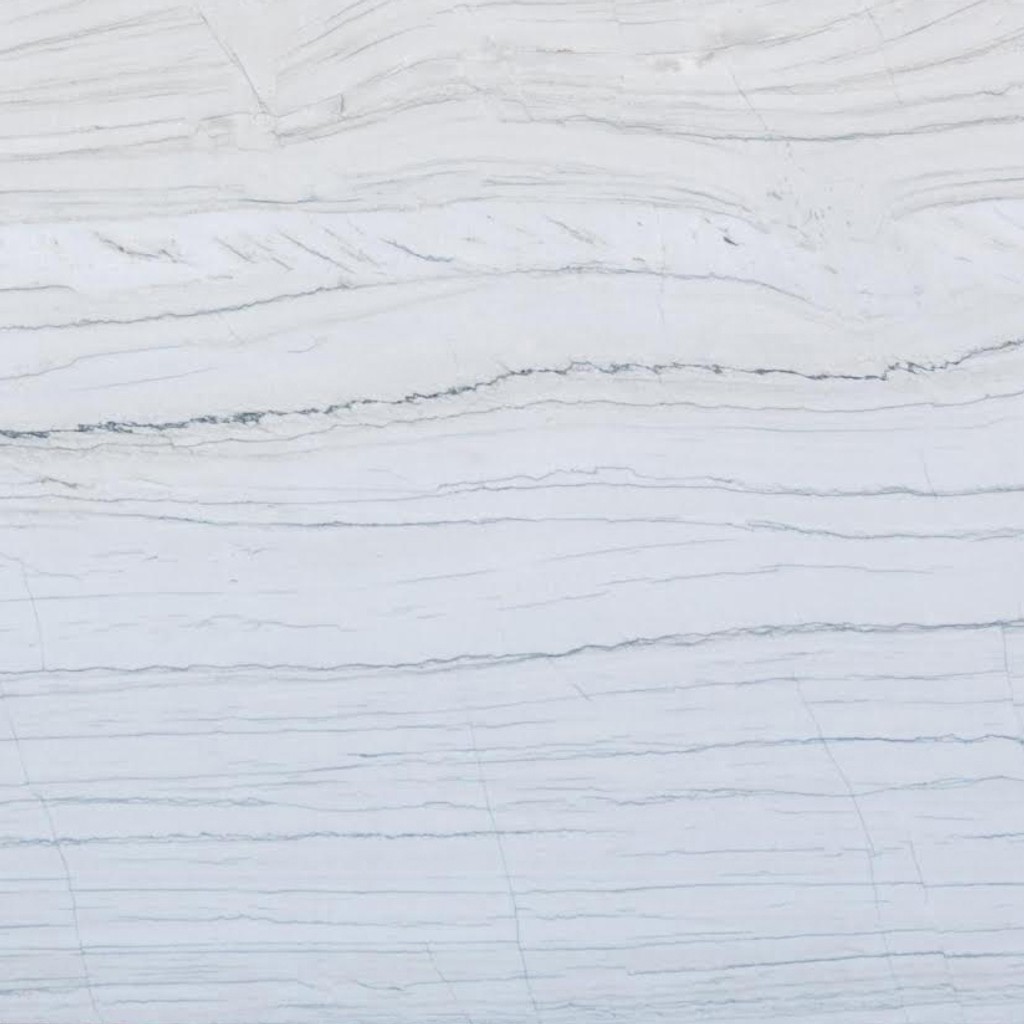 a Macaubas Fantasy quartz countertop surface that features white and gray veins over the soft gray background