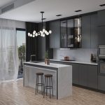 a modern kitchen with gray cabinetry with kitchen ware, volakano countertops and waterfall kitchen island with decorative plants and alcoholic beverage, lighting fixture, kitchen appliances, and hardwood floors