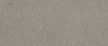 a smokey quartz countertop surface that has a gray design with granular design of gray and white specks