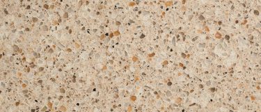 a saturn quartz countertop surface that has a beige background with warm color grains
