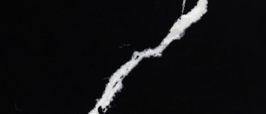 a Nero Marquino quartz countertop surface that has striking white veining pattern over the deep black background
