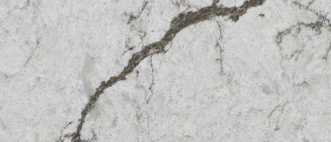 a Diamante quartz countertop surface that features dark veins over the white background
