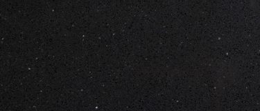 a Crystal Black quartz countertop surface that has glass-like fragments over the black background