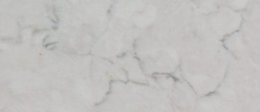 a Crema Chiffon quartz countertop surface that features brown-gray veining pattern over the cream background