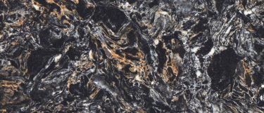 a Cosmic Black quartz countertop surface that features a dark design with colors of white, burnt orange, and black