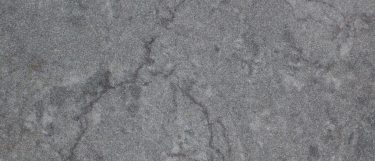 a Blue Savoy quartz countertop surface that features veins on a dark blue background