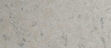 an Avalon quartz countertop surface that has a light gray color and a grainy pattern