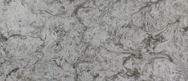 an Avalanche quartz countertop surface that features swirls of creamy white and brown with gray vein details