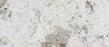 an Alaska White quartz countertop surface that features gray speckles over the crisp white background