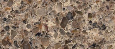 a sienna ridge quartz countertop surface that features pebble-like pattern in medium to dark brown shades