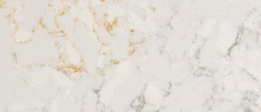 a pulsar quartz countertop surface that has cream and delicate gray veins over the white base