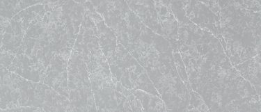 a Polaris quartz countertop surface that has a gray design with white veining and light gray flecks