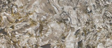 a Pacifica countertop surface that features swirling pattern in gray, beige, and charcoal over the beige-cream base