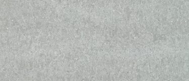 an Ocean Jasper F quartz countertop surface that has a light gray background with veining pattern in white, beige, and gray
