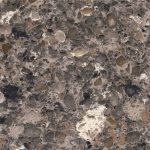 a mountain mist quartz countertop surface that has a brown color and pebble-like pattern in gray, brown, and black