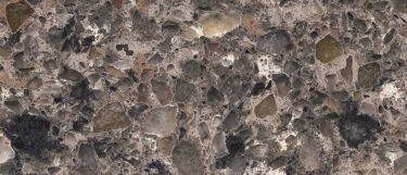a mountain mist quartz countertop surface that has a brown color and pebble-like pattern in gray, brown, and black