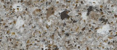 a Forest Snow quartz countertop that features brown, gold, beige, and white splotches over its brown surface
