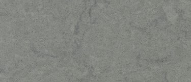 a Cygnus quartz countertop surface that has a greenish gray tone with subtle gray veins and grains