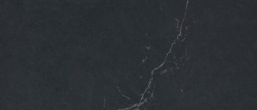 a Charcoal Soapstone quartz countertop surface that features gray highlight details over the blue-gray background