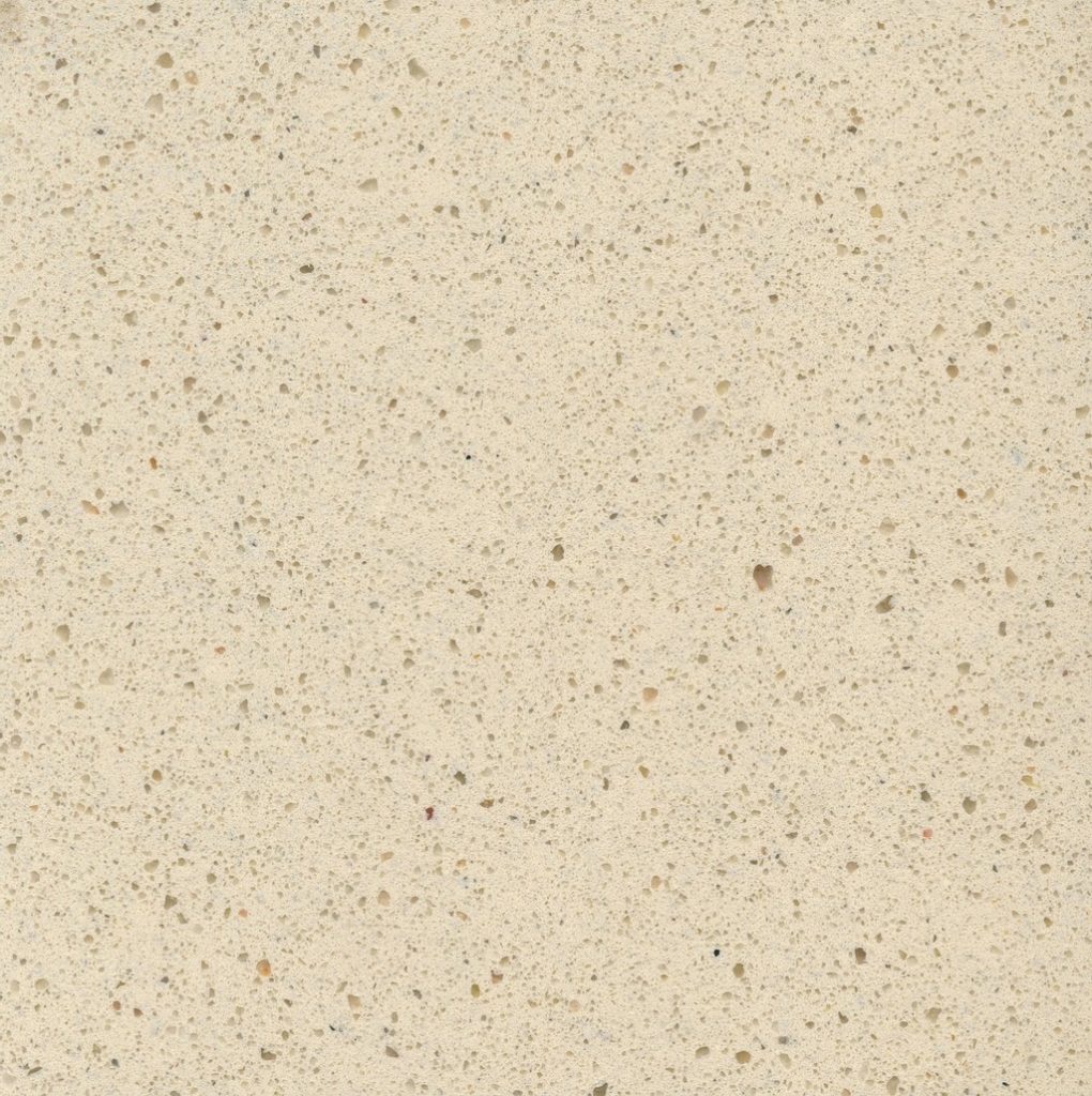 a Blanco Capri quartz countertop surface that has a beige color dotted in black, gray, and yellow specks