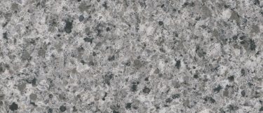 a pearl gray quartz countertop surface that features a pebble design with gray grain specs in gray and white