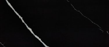 a Marquina Midnight quartz countertop surface that has a black base with dramatic white veining