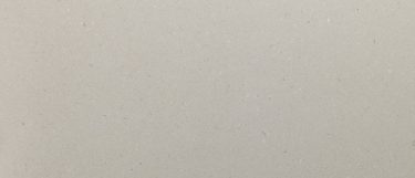 a Fossil Taupe quartz countertop surface that has a mid-tone taupe background with specks detail